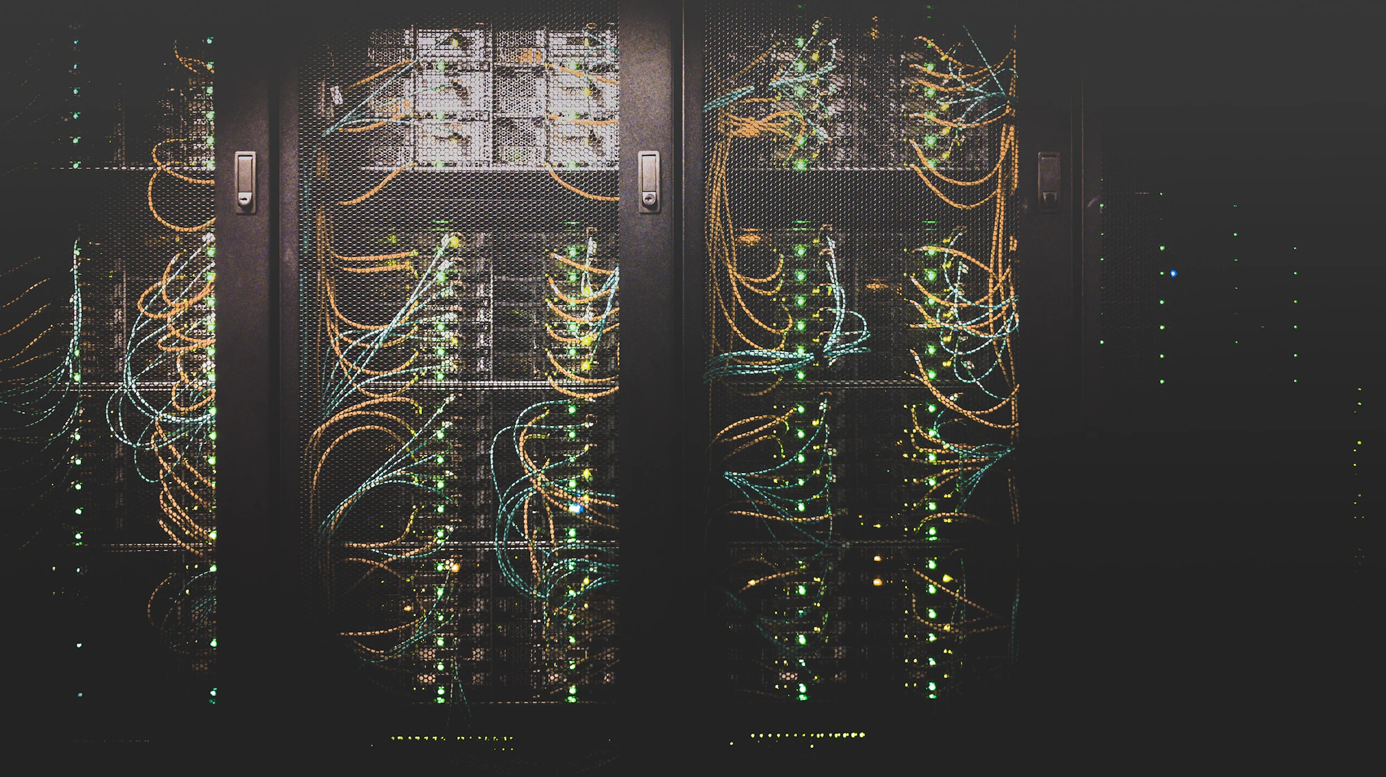 Data centre corridor lit by blue server rack lights